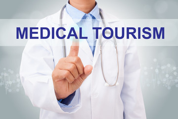 Doctor hand touching medical tourism sign on virtual screen. medical concept