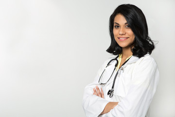 Hispanic doctor in an exam room.