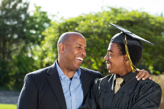 African American Father And Son At Graduation.