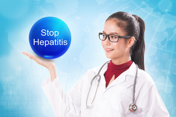 Female doctor holding blue crystal ball with stop hepatitis sign on medical background.