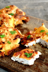 Turkey breast steaks fried in egg batter in olive oil. Delicious Turkey meat cutlets on wooden background. A rustic style. Cooking meat idea
