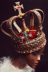 Mannequin in creative golden crown on background