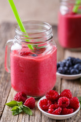 Healthy smoothie with raspberries, berries on plates and drinkin