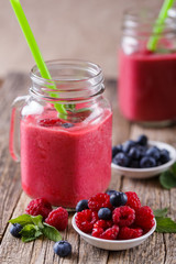 Healthy smoothie with raspberries, berries on plates and drinkin