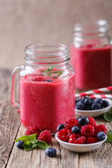 Healthy smoothie with raspberries, berries on plates and drinkin