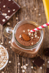 Detox chocolate smoothie with cereals in glass jar.