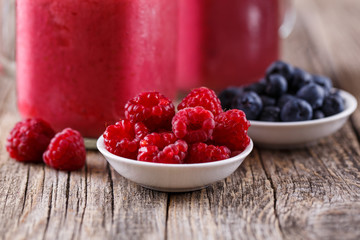 Plates with berries and smoothie background.