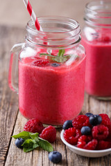 Healthy smoothie with raspberries, berries on plates and drinkin