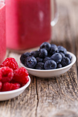 Plates with berries and smoothie background.