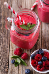 Healthy smoothie with raspberries, berries on plates and drinkin