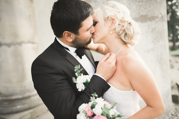 Kissing wedding couple in spring nature close-up portrait