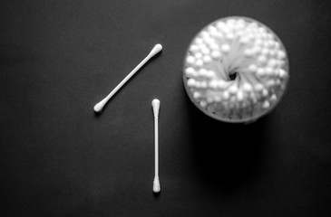 Cotton buds on black background.