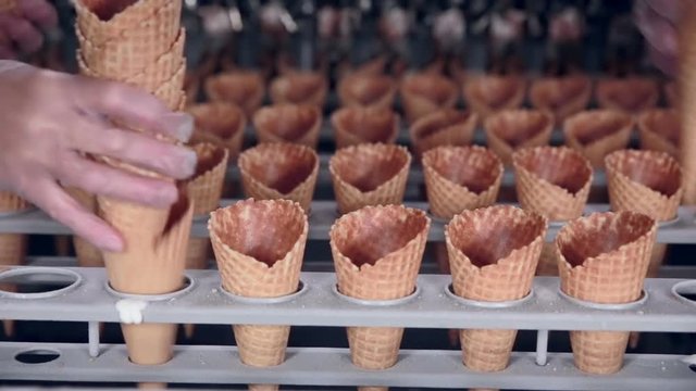 Modern equipment at the food factory. Automatic Machine producing ice-cream cones. 1080p.