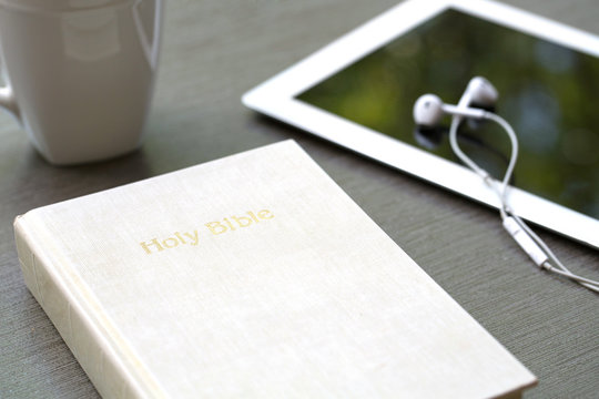 Contemporary image of a Bible with headphones.