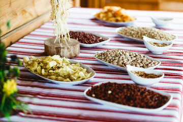 Salty appetizers lie on the table covered with ethnic cloth