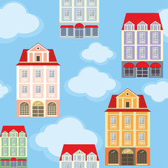 seamless pattern with the image of old town houses and clouds.