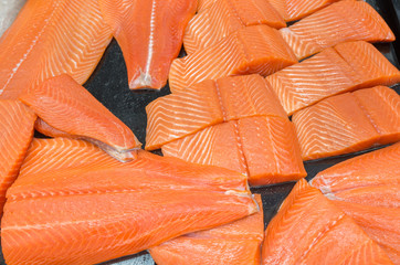 Salmon filleted for sale at fish market displayed
