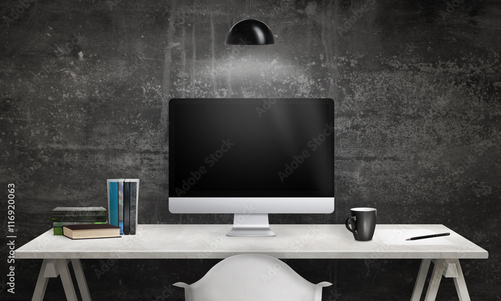 Poster Computer display and books on office desk. Blank screen for mockup. Dark, black wall in background. Hanging lamp on top.