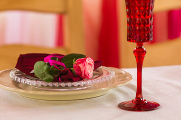 Wedding summer table set decoration with flowers. White plate, red wineglass