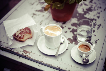 Coffee and donuts on vintage table