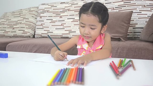Cute asian Thai little girl drawing