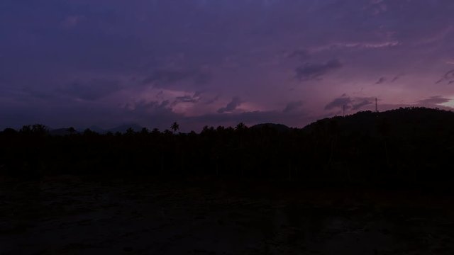 Scenic sunset timelapse in Sri Lanka. Evening clouds moving fast over palmtrees
