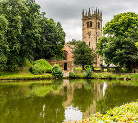 Fototapeta na wymiar Gawesworth, Cheshire, UK. July 26th 2016. Attractive Gawesworth village church behind village pond at Gawesworthl, Cheshire, UK