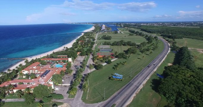 Bird's-eye view above tropical island and a bay of calm Atlantic Ocean. Drone flies over the main road leading to Varadero.