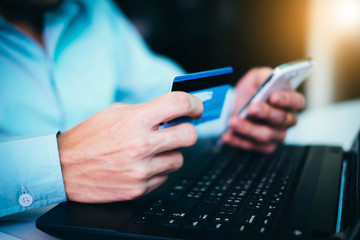 man hands with smartphone and credit card as online shopping