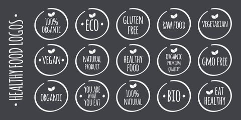 Vector white food logo on grey. 100% Organic, Eco, Gluten, GMO Free, Raw, Bio, Vegetarian, Vegan, Natural Product, Premium Quality, You are what you eat,  Eat Healthy symbols - obrazy, fototapety, plakaty
