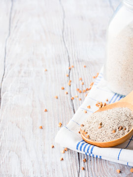 Gluten free buckwheat flour on wooden background. Vertical image