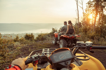 Beautiful couple is watching the sunset from the mountain sittin © diter