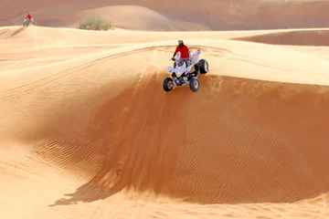 Foto auf Leinwand Extreme sport. ATV drives off the sand dunes © go2dim