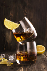 Cognac in glasses over wooden table