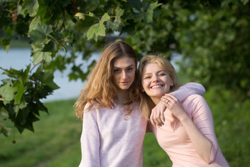 Fototapeta premium Two girls hug and smile