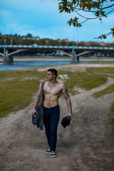 Sexy muscular man with bag