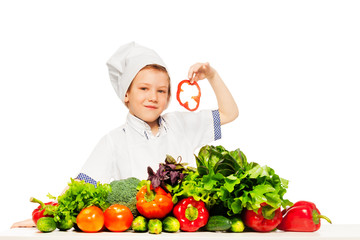 Kid boy playing chef cook preparing fresh salad