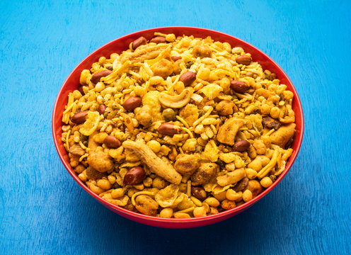Traditional indian deep fried salty dish - chivda or mixture or farsan or farsaan made of gram flour and mixed with dry fruits