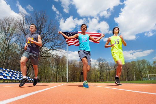 Winning runners with USA flag celebrating victory