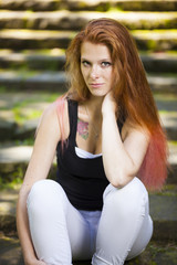 Obraz premium young red haired woman student relaxing learning in park sunny weather summer
