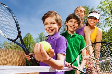 Poster Im Rahmen Family playing tennis holding rackets and ball © Sergey Novikov
