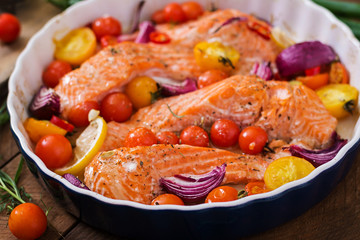 Baked salmon fillet with tomatoes, red onions and spices. Diet menu.