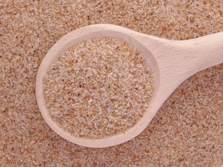 Psyllium seeds husks in wooden spoon
