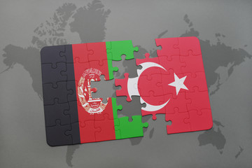 puzzle with the national flag of afghanistan and turkey on a world map background.
