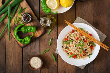 Udon noodles with meat and vegetables in an Asian style. Top view