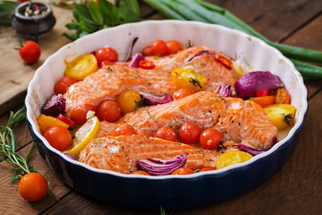 Baked salmon fillet with tomatoes, red onions and spices. Diet menu.