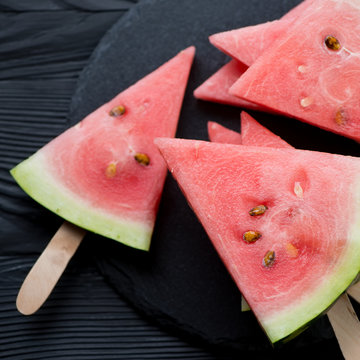 Close-up of ripe and juicy watermelon slices on sticks