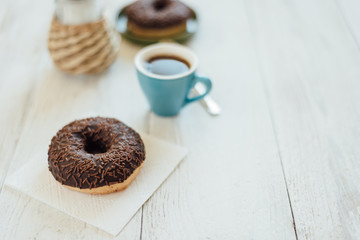 Breakfast in cafe with chocolate donut and coffee