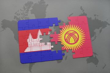 puzzle with the national flag of cambodia and kyrgyzstan on a world map background.
