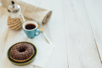 Breakfast in cafe with chocolate donut and coffee